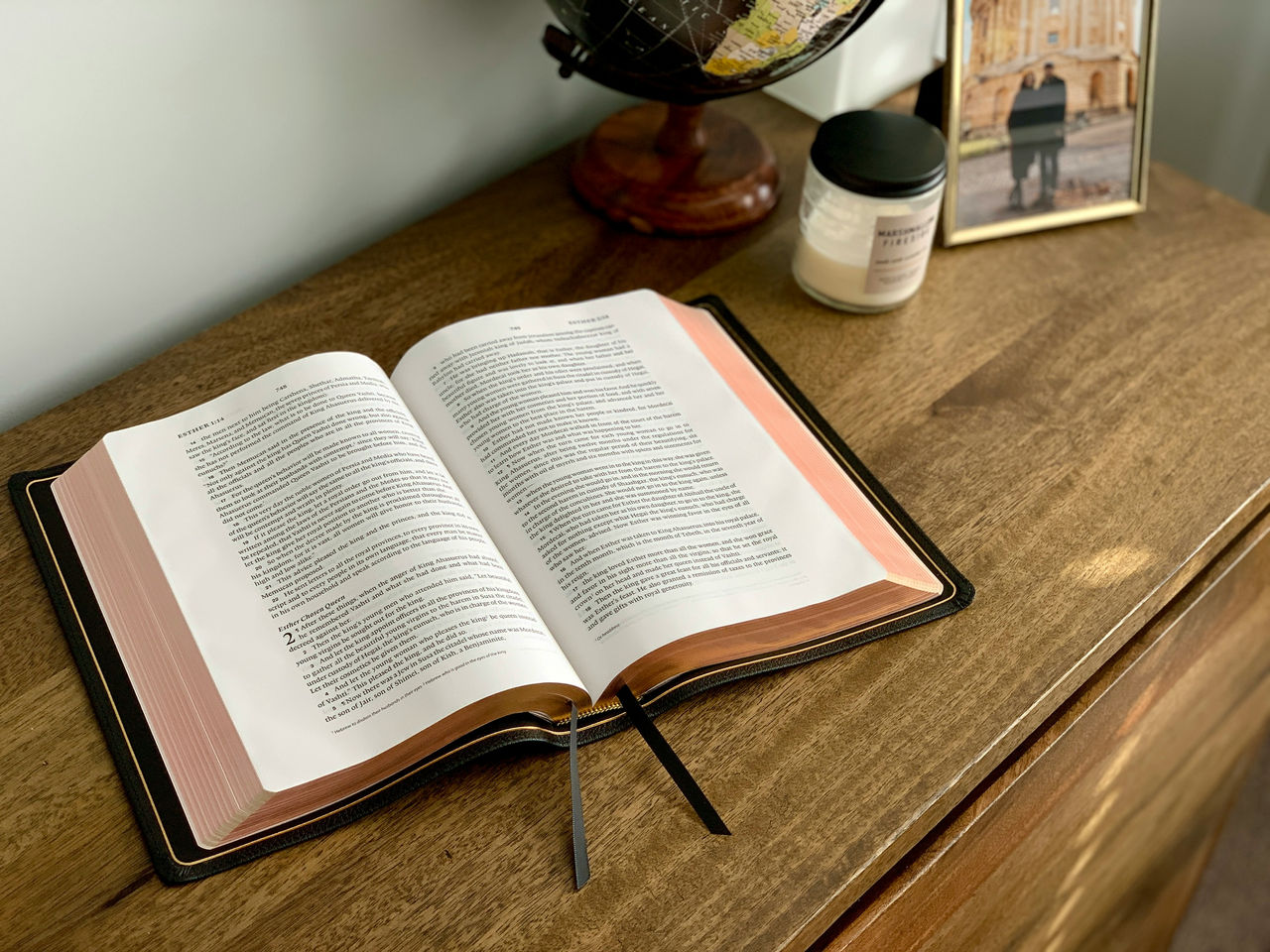 white bible page open on brown table
